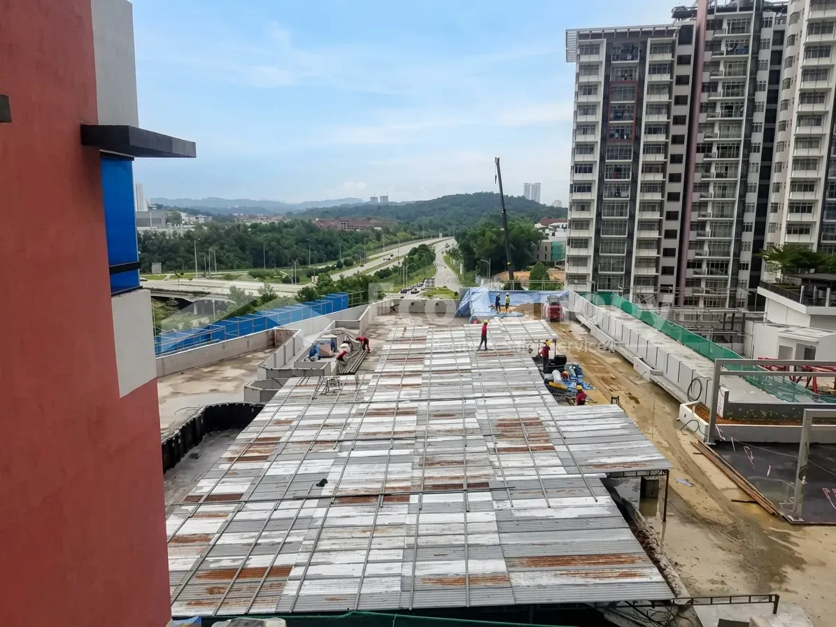 Long zinc tent roof covering part of a construction site in KL